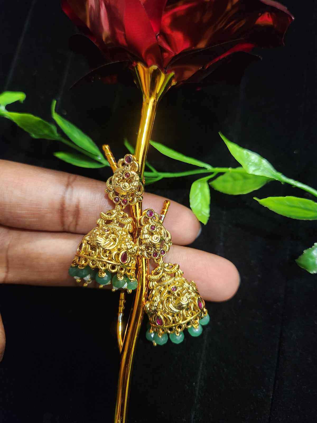 Antique Finish Peacock Design Jhumka with Ruby Accents & Green Bead Drops